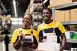 © DC Studio - Colleagues recording a live stream vlog in warehouse industrial space, showcasing product handling and order fulfillment. Black smiling team presenting goods for a promotional advertisement.