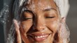 © Mas - Woman washing face with foam close up