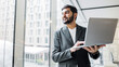 © muse studio - Businessman working with laptop in office setting