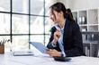 © David - Business asian woman working at office with tablet and document, doing planning analyzing the financial report Tax Advisory Firm.