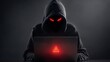© ittipol - A mysterious figure in a dark hoodie sits before a laptop, its screen glowing ominously with a warning symbol, symbolizing cyber threats and digital security issues.