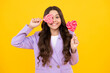 © Olena - Funny child with lollipop over yellow isolated background. Sweet childhood life. Teen girl with yummy caramel lollipop, candy shop. Happy teenager, positive and smiling emotions of teen girl.