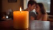© Thares2020 - A candle casts a warm glow on a couple embracing intimately in soft blurred background lighting