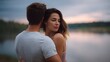 © Thares2020 - A couple shares a tender embrace by a tranquil lake at dawn bathed in soft light
