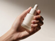 © pho.xoio - Hand Holding Minimal Cosmetic Dropper Bottle with Soft Shadow on Neutral Background