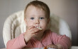 © splitov27 - Little baby eats cheesecakes at the feeding table