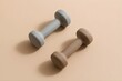 © D'Claret - Minimalist Fitness Dumbbells on Warm Beige Background with Soft Natural Light, Clean Home Workout Equipment Concept in Neutral Tones, Modern Wellness Lifestyle, Photorealistic Stock Image