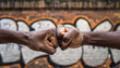 © devilvet - Two African American Men Fist Bumping Against Graffiti Wall
