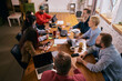 © master1305 - Creative team meeting viewed from above in modern office. Concept of strategic discussion, collaborative planning, teamwork dynamics and contemporary coworking business environment.