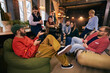 © master1305 - Group of coworkers relaxing and talking in modern workspace. Concept of informal communication, team bonding, healthy work culture, and startup office lifestyle.