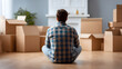 © utaem2022 - Man contemplating future new home with moving boxes