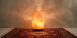 Pink Himalayan salt lamp placed on an asiatic carpet, home decor safety considerations