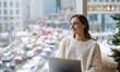 © simba kim - A confident, happy woman sitting comfortably at home, smiling while looking at her laptop. She looks relaxed, productive, and satisfied. Behind her, a large window reveals a contrasting scene