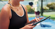 © EineroLens/peopleimages.com - Hands, tablet and scroll at tennis court for exercise, game planning or notes for padel match at urban park. Person, tech and coach with application, checklist and sign up for fitness at sports club