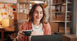 © EineroLens/peopleimages.com - Woman, coffee and smile with laptop at small business for ecommerce, supply chain and online order. Female person, morning beverage and pc for logistics, inventory management and schedule shipping