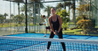 © peopleimages.com - Sports, padel and people on court for exercise, training and practice for competition outdoor. Tennis, athlete team and man and woman with racket for playing game, match and tournament for challenge