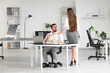 © Pixel-Shot - Young woman seducing her boss on desk in office. Harassment concept
