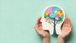 © ANMZAKARIA - Hands holding paper cutout profile with colorful brain and flowers | Concept of mental wellbeing and psychological health | Creative expression and nurturing positive mental growth | Symbolic represen