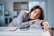 © Tj - Asian businesswoman sleeping on desk feeling exhausted and overworked
