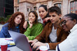 © Gigi Delgado - Multiracial group of students gathering to study at university campus, concentrated looking at a laptop together, working on a school project as a teamwork. Copy space.