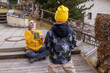 © Guzel - Man makes bubbles for child in outdoor space during late afternoon in a garden area