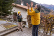 © Guzel - Two people play a game outside a house in the mountains during the daytime in autumn with wooden deck and trees nearby