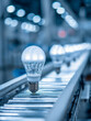 © Yurij - Modern electric bulbs moving along an automated conveyor belt in a high-tech manufacturing facility with bright industrial lighting in the background
