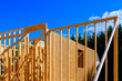 © ungvar - Workers are busy framing new wooden building is beams