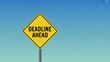 © Designer - Yellow Diamond 'Deadline Ahead' Warning Sign Against Blue Sky