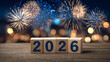© Patryk Wolanowski - Nowy Rok 2026 z drewnianymi klockami i fajerwerkami na niebieskim tle