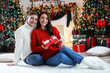 © New Africa - Happy couple with Christmas gift at home