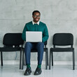 © Lumos sp - Portrait of a young businessman  or a young entrepreneur or a student young man using laptop working in office waiting for an interview job application