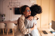 © Jelena - Warm Embrace Between Friends In Modern Office Setting Celebrating Support And Connection At Work