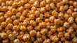 © Fathia A.M. - Caramel popcorn background texture, sweet golden coated corn snack close-up