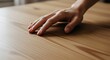 © Sudegan - Sensory experience of a hand gliding across a sleek wooden surface