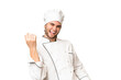 © luismolinero - Young handsome chef man over isolated background making guitar gesture