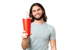 © luismolinero - Young handsome man holding soda over isolated chroma key background with happy expression