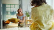 © stockbusters - Overjoyed girlfriends fighting pillows in comfortable living room. Joyful women