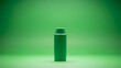 © Nasrul - A green cylindrical container with a screw-on cap stands alone on a green gradient background with soft lighting.