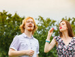 © Voyagerix - Couple blowing soap bubbles, having fun