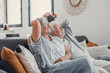 © Daniel - carefree senior mature couple relaxing on comfortable couch and napping together at home. dreamy elderly man and woman nap on sofa in living room and enjoy weekend