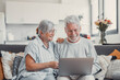 © Daniel - House, laptop and senior couple on sofa, finance planning or connection in living room. Mature people, apartment or man with woman, computer or internet with budget, savings or real estate in lounge