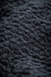 © Alexander - The texture of a soft black fleece fabric with visible fibers and folds