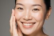 © Studicon - Radiant woman gently touching face with peeling mask for skin rejuvenation