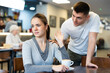 © JackF - Girl rejects guy. Young man violates personal boundaries of female cafe visitor, distracts her. Girl pushes away annoying guy