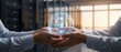 © Graphic Genius - Two hands holding glowing digital security sphere concept, symbolizing digital trust and data protection in a server room environment.
