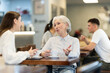 © JackF - Elderly woman and her adult daughter sit together at table in cafe