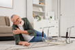 © Pixel-Shot - Senior man lying on floor after fall with walker at home