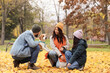 © Pixel-Shot - Happy family with Beagle dog in autumn park