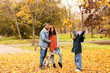 © Pixel-Shot - Cute Asian girl throwing leaves with her parents and Beagle dog in autumn park